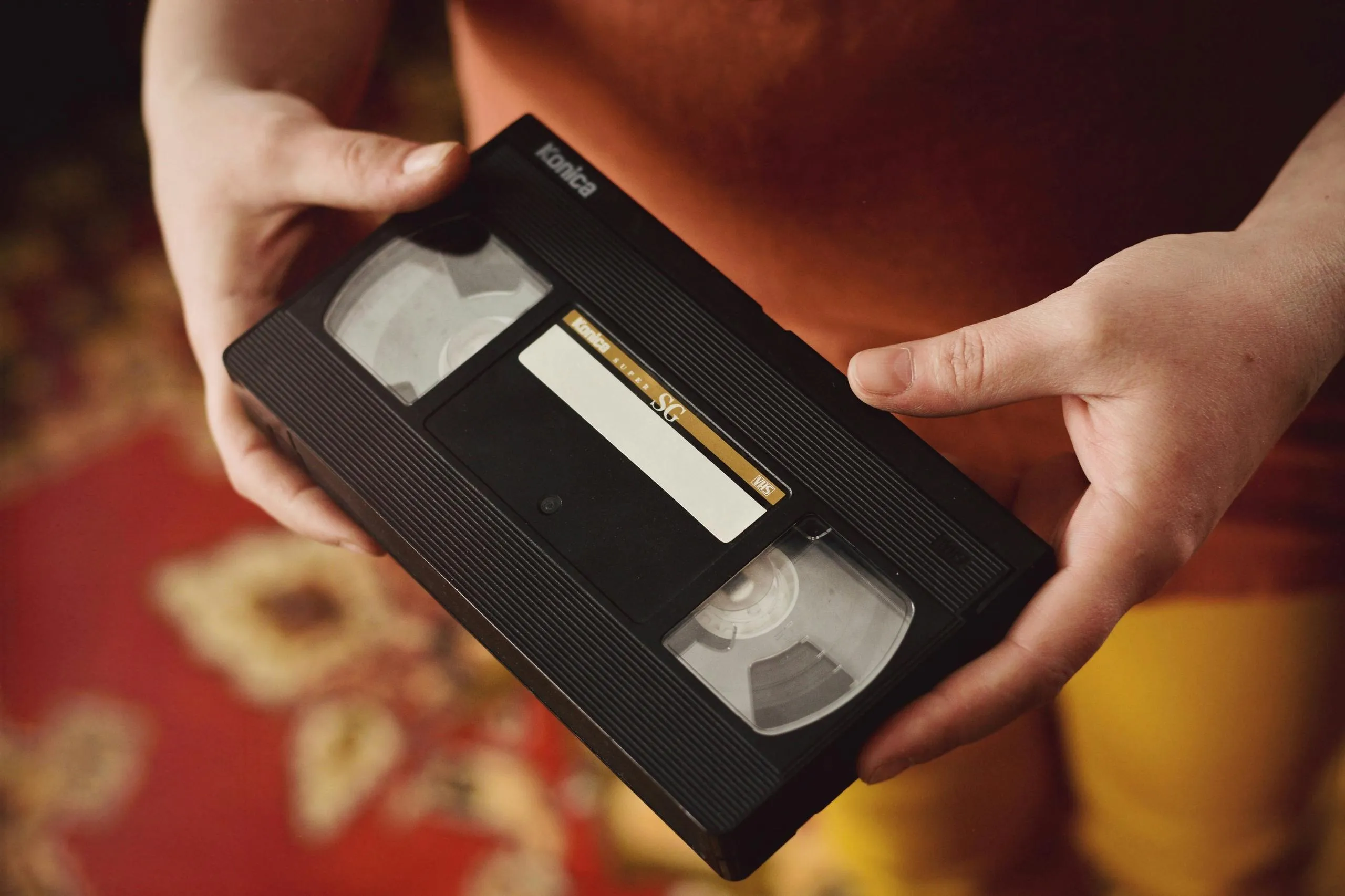両手でVHSテープを持っている写真